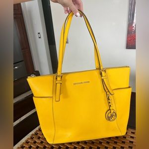 Yellow Michael Kors jet set small hand bag.
